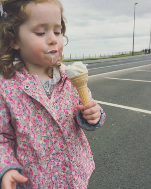 istock Little Girl Eating an Ice Cream Cone 1152209261