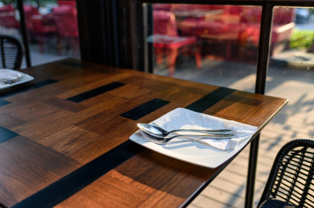 istock White dish with fork and spoon on wooden dining table 1152209983
