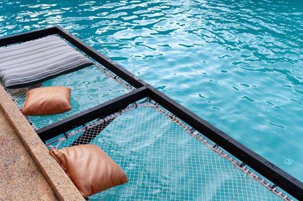 istock Mesh seat with pillows jut out on swimming pool 1152209993