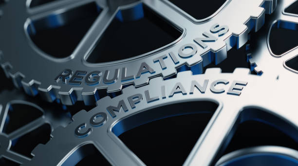Metal Cogs With Regulations And Compliance Text - Compliance Concept Metal cogs are turning. Regulations and compliance words are written on the cogs. Horizontal composition with copy space. compliance stock pictures, royalty-free photos & images