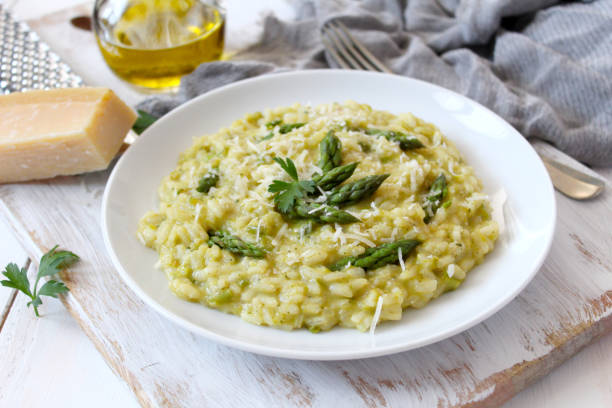 istock Italian risotto with asparagus and parmesan cheese on light background. 1152213634