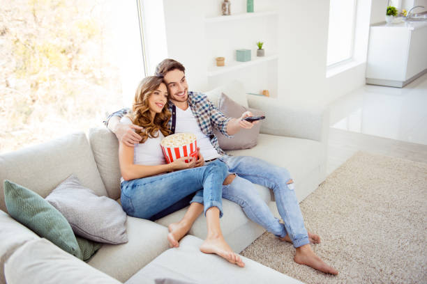 above high angle view of his he her she two person nice attractive cheerful guy lady sitting on divan eating corn watching new drama comedy in light white style interior living room hotel house - remote television movie box imagens e fotografias de stock