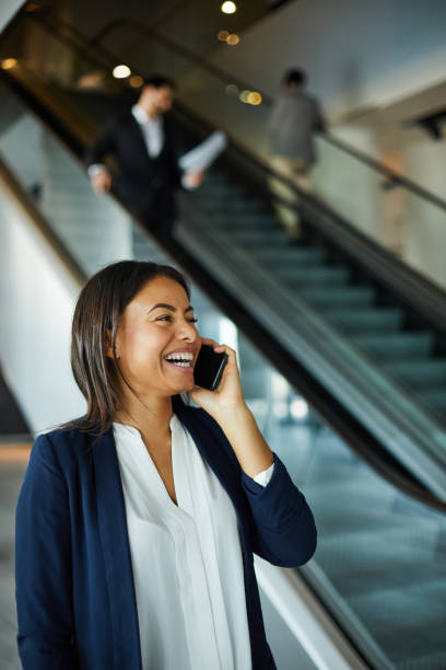 istock Excited black woman laughing while talking on phone 1152213793