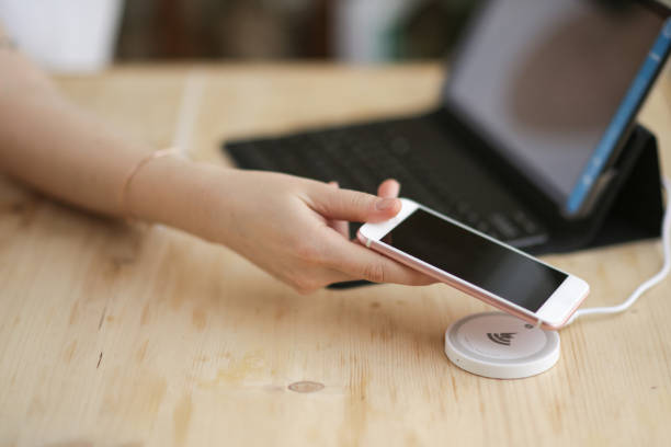 istock phone charging on wireless charger device 1152214223