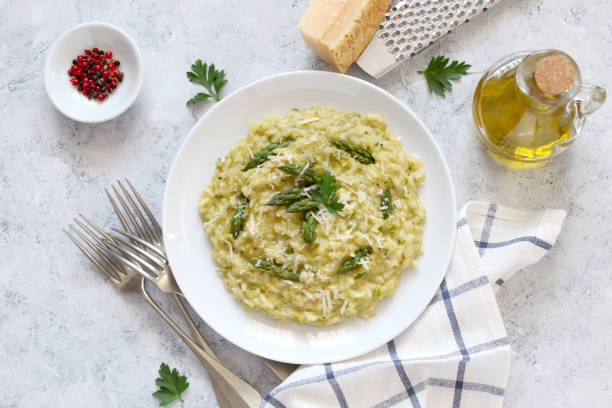 istock Italian risotto with asparagus and parmesan cheese on light background. 1152215337