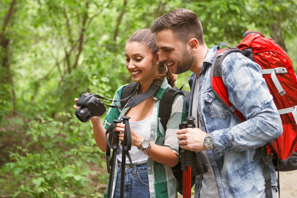 istock Young couple looking through interesting photos during hiking 1152215359