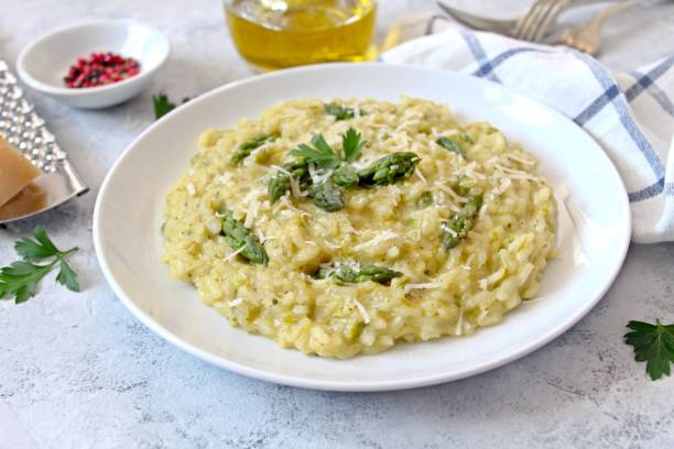 istock Italian risotto with asparagus and parmesan cheese on light background. 1152215971