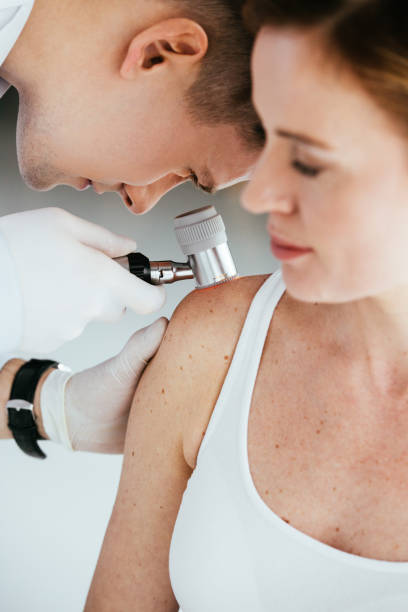 istock selective focus of dermatologist holding dermatoscope while examining patient with melanoma 1152216273