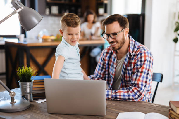 istock Father and son using laptop at home 1152217676