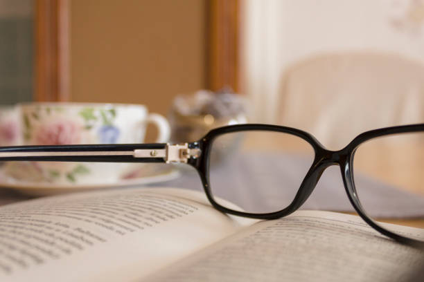 istock book, eyeglasses and tea on table 1152217696
