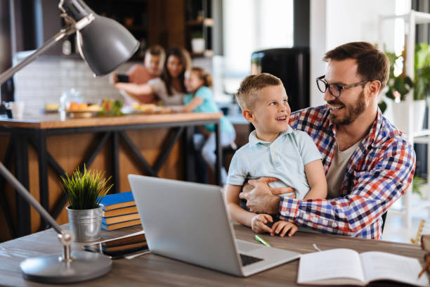 istock Father and son using laptop at home 1152218403