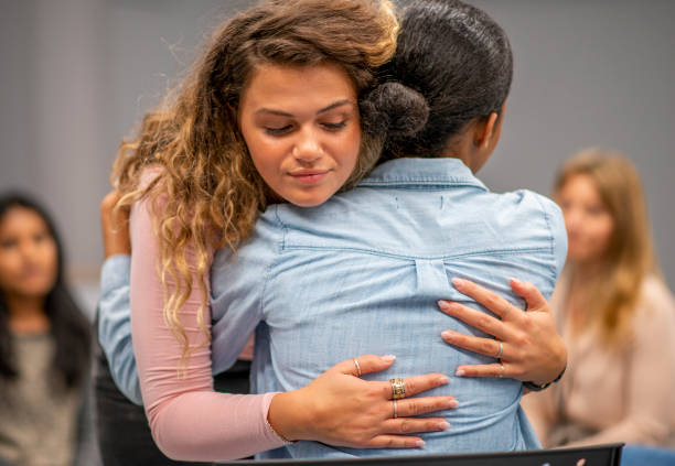 istock Young adults comforting each other at group therapy 1152218586