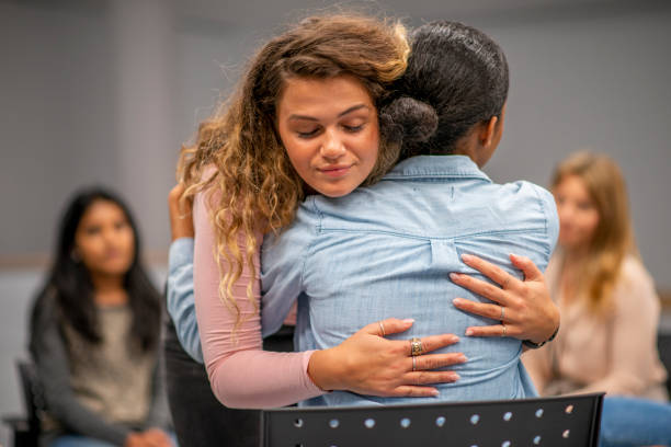 istock Young adults comforting each other at group therapy 1152218854