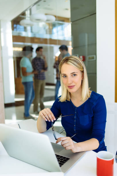 istock Successful young woman in modern office working on laptop 1152219518