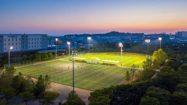 Aerial view Sunset at Incheon industrial Park and Player Football field at Night. Aerial view Sunset at Incheon industrial Park and Player Football field at Night. incheon industry South korea songdo ibd stock pictures, royalty-free photos & images