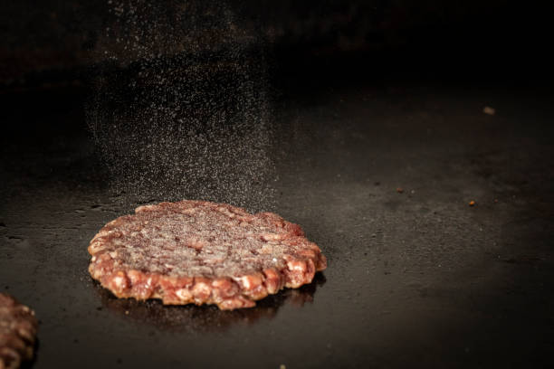 hamburger meat cooking on hot griddle salt griddle stock pictures, royalty-free photos & images