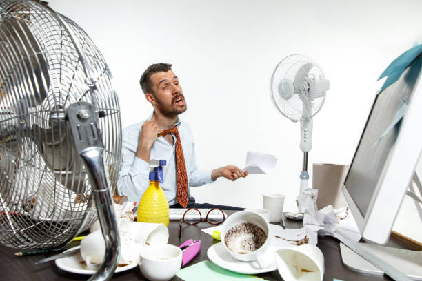 młody człowiek cierpiący na ciepło w biurze - heat effort emotional stress business zdjęcia i obrazy z banku zdjęć