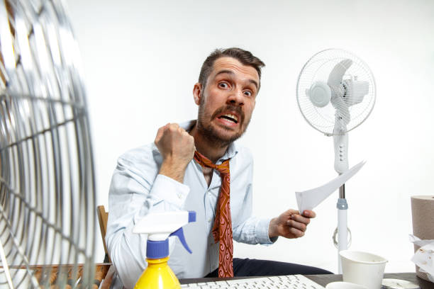 istock Young man suffering from the heat in the office 1152226609
