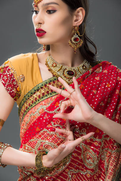 istock indian woman in traditional sari gesturing isolated on grey 1152228111