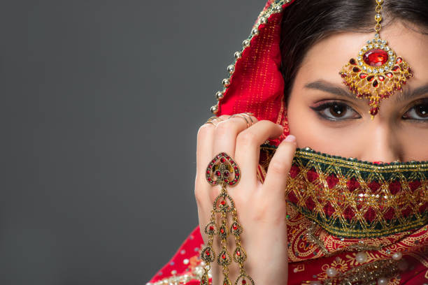 istock indian woman posing in traditional sari and bindi, isolated on grey 1152228573