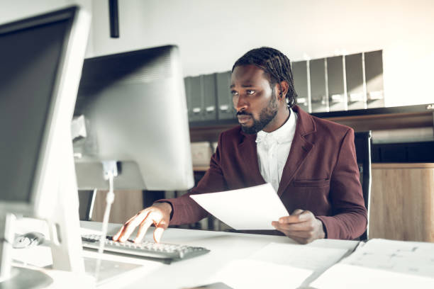 istock Dark-skinned businessman working on computer in the office 1152229641