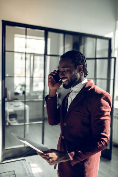 istock Bearded businessman smiling while calling his wife from office 1152229687