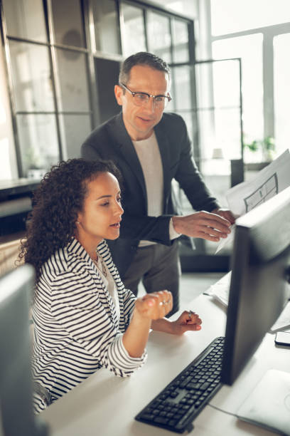 istock Curly African-American trainee asking her boss some questions 1152229807