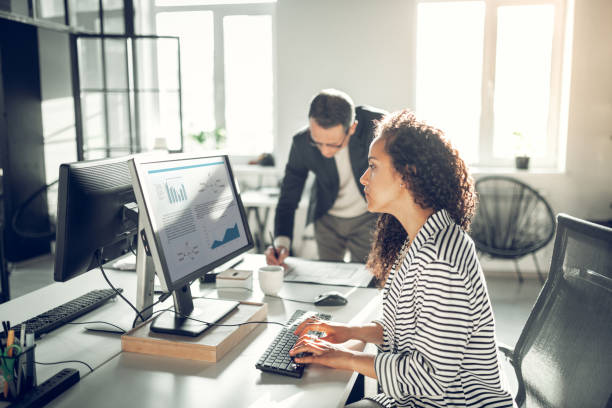 istock Curly assistant searching information for her boss 1152229826