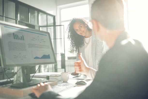 istock Businessman showing thumb up while approving work of his trainee 1152229836