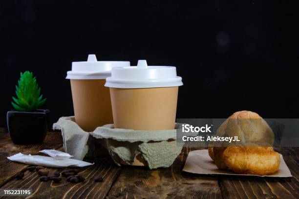 Paper Cups Of Coffee Sugar In Bags Donuts Croissant Wooden Table Black Background Stock Photo - Download Image Now