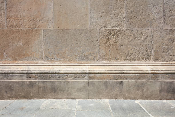 istock Old stone wall with molding and floor background in sunlight, nobody 1152232375