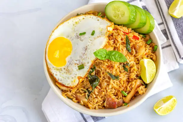 Thai Chili Basil Fried Rice with Fried Egg on Top. Fried Rice with Vegetables and Fried Egg, Thai Cuisine, Thai Food, Asian Food Photography.