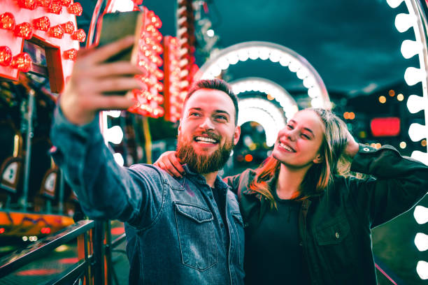 istock Beautiful Couple Taking Selfie At Theme Park 1152238193