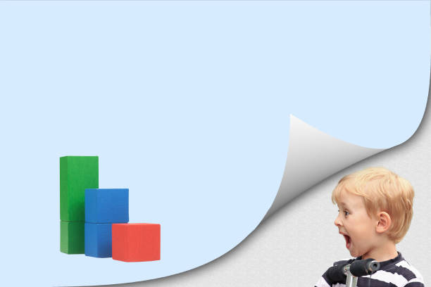 istock Surprised boy is looking at graph of wooden cubes 1152239594
