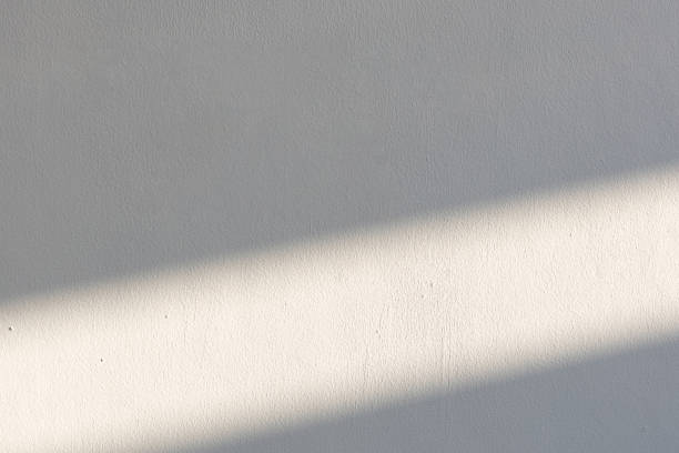 istock simplicity empty white cement wall with line of sun light and shadow at afternoon. used for template, background or texture. 1152240599