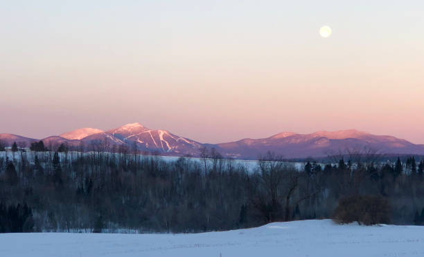 Jay Peak Sunrise and Moonset Early morning sunrise on Jay Peak as moon is setting. jay photos stock pictures, royalty-free photos & images