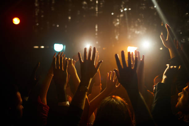 istock People waving hands at concert 1152246066