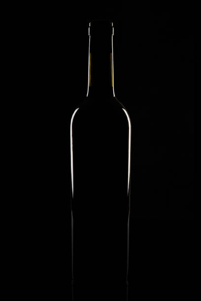 istock Isolated bordeaux wine bottle, dark background silhouette 1152247546