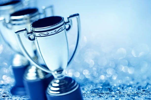 istock Row Of Trophies With Glitter And Confetti 1152251342