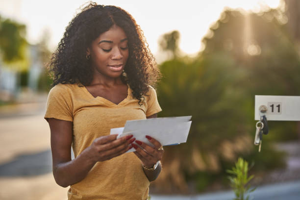 african american woman checking mail in las vegas community african american woman checking mail in las vegas community during the day mailbox photos stock pictures, royalty-free photos & images