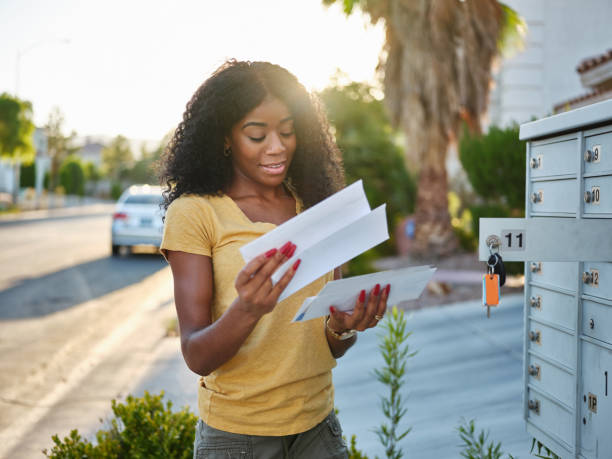african american woman checking mail in las vegas community stock photo