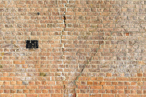 Large cracks in a brick wall due to subsidence