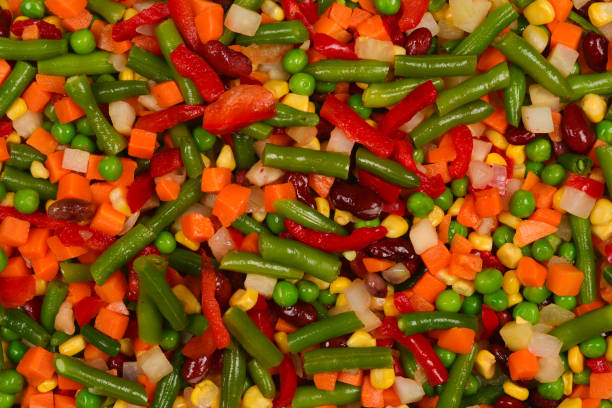 istock Sliced vegetables, corn, beans, peas, carrots, sweet peppers background. 1152257794