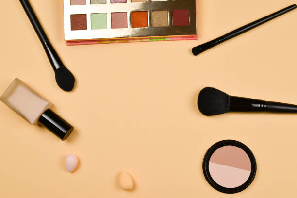 istock Professional trendy makeup products with cosmetic beauty products, foundation, lipstick,  eye shadows, eye lashes, brushes and tools. 1152257802