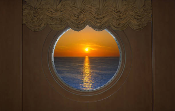 istock Beautiful Sunset Seen Through a round Ship Porthole 1152258272