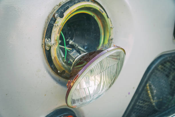 istock Broken car headlight hanging on the wires 1152258890