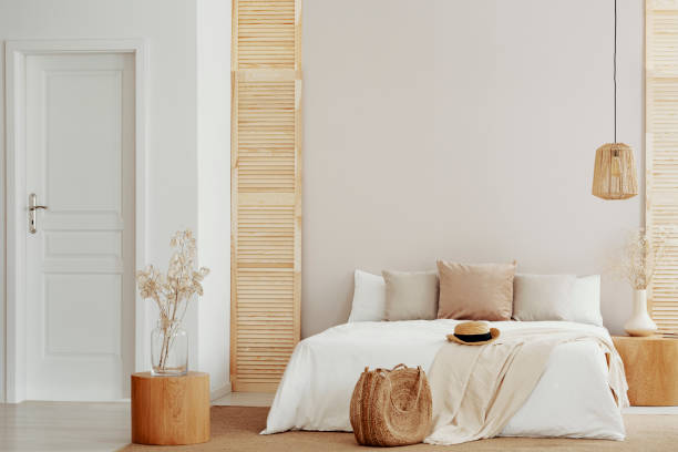 istock King size bed with white and beige bedding in stylish bedroom, copy space on empty wall 1152262738