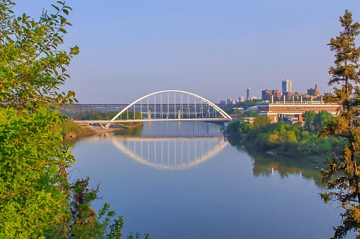 A view of the Walterdale bridge in Edmonton and its reflection on the river