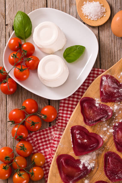 istock Red heart ravioli with tomato, mozzarella and basil. 1152262954