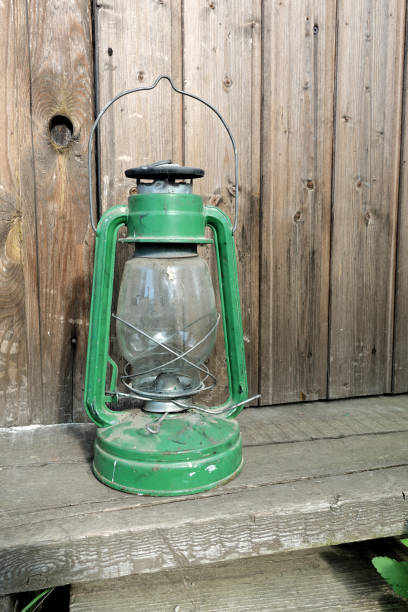 istock Kerosene lamp on rustic wooden planks background 1152263916